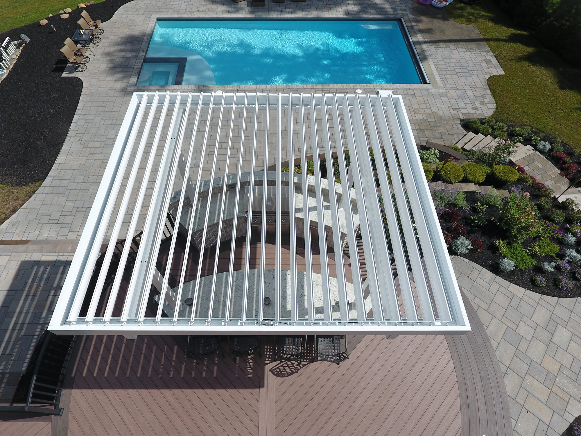 Custom louvered pergola over outdoor living space installed by Rainier Shade