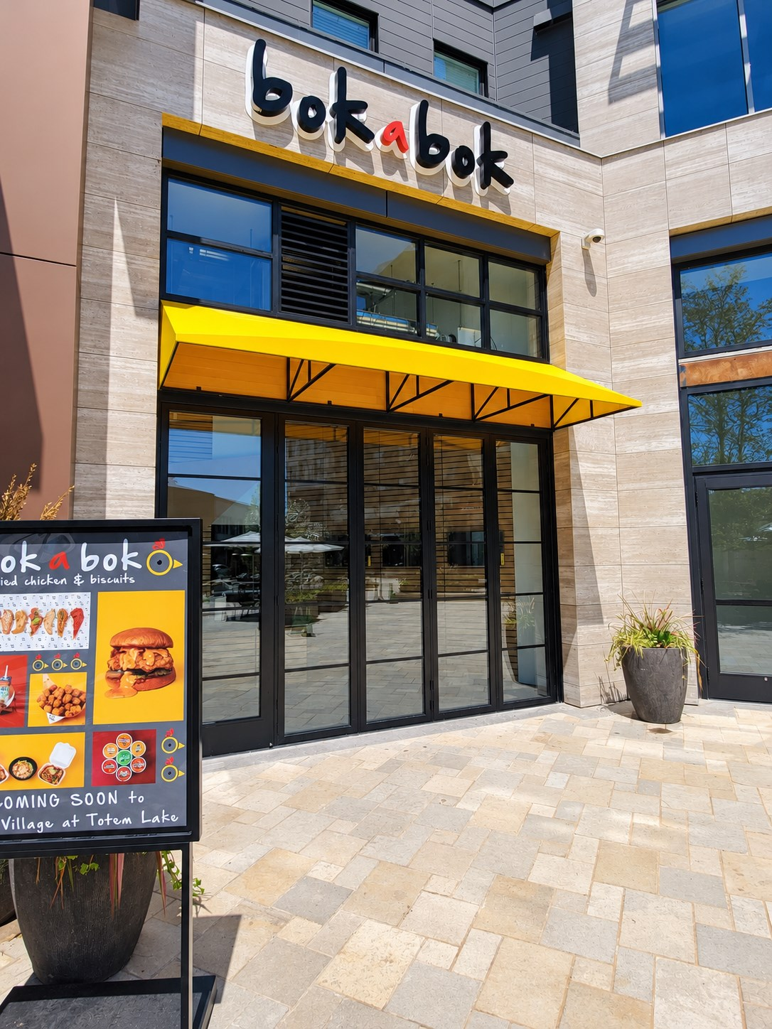 Yellow fabric storefront awning over a restaurant entrance