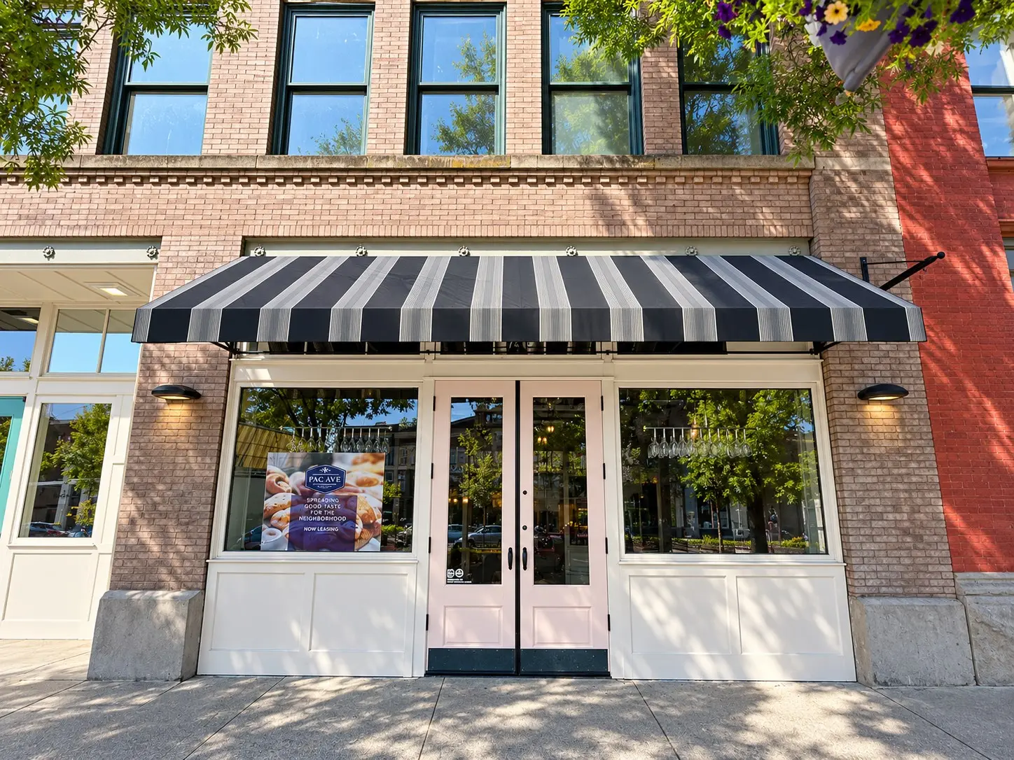 Recovered striped wedge awning on a brick storefront in Tacoma, WA