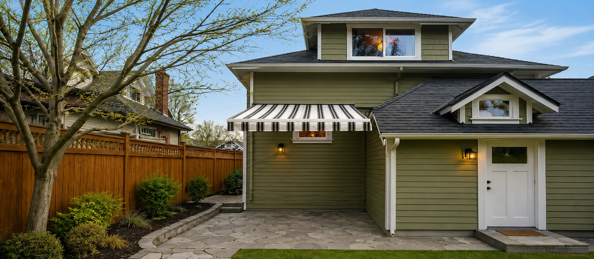 Rainier cross-arm retractable awning over a narrow side-yard patio