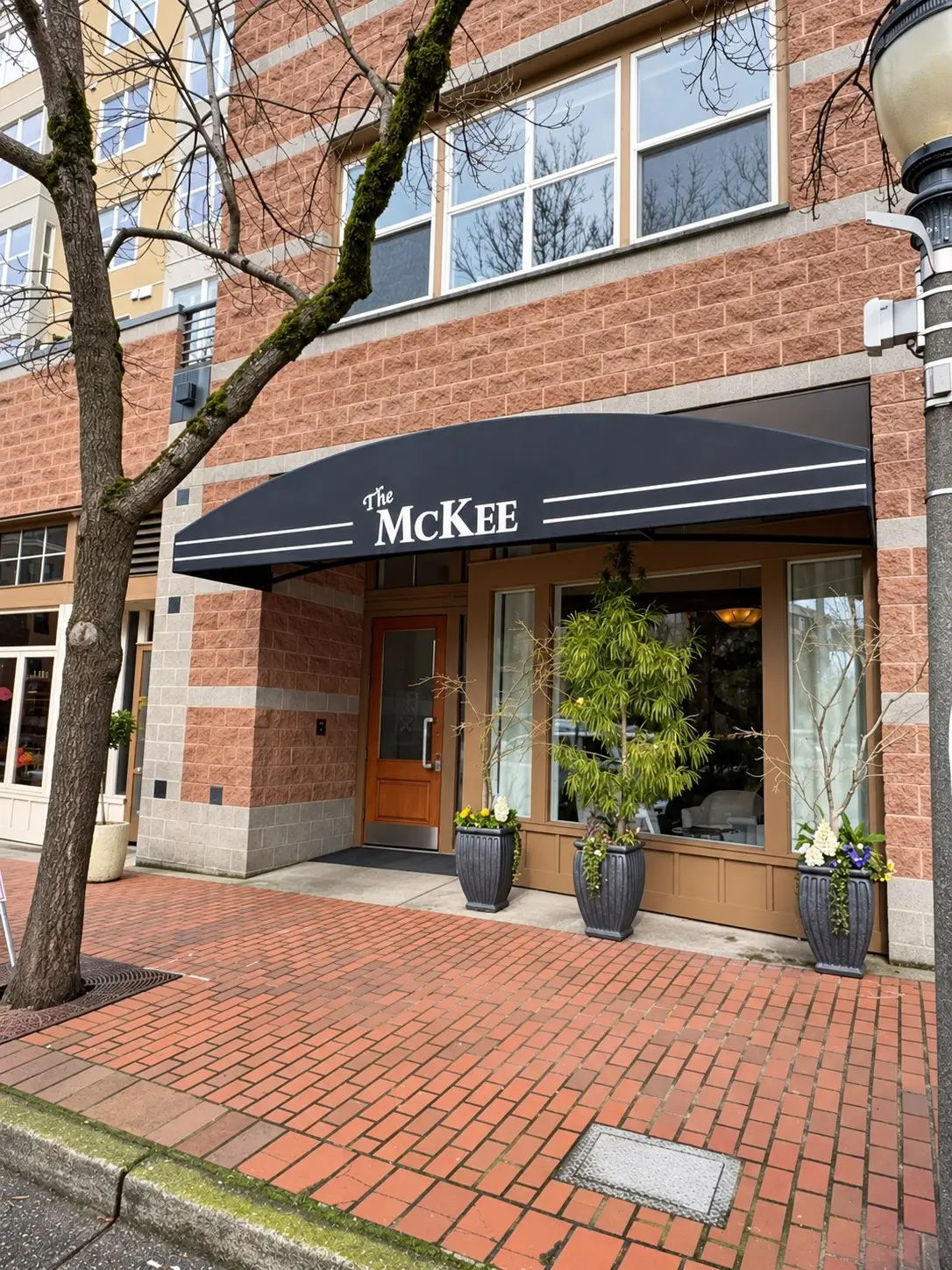 Recovered black entry awning with building name graphics at a Bellevue condominium