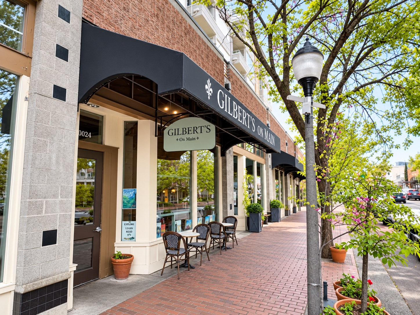 Black storefront awnings with restaurant graphics along a Bellevue retail street